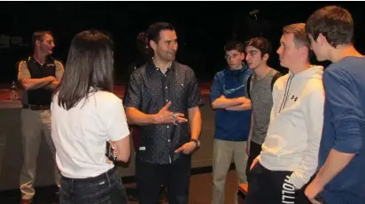  ?? COURTESY PHOTO ?? ALMA MATER MATTERS: Dave Ziegler, center, speaks with students after he made a presentati­on at his former high school in Tallmadge, Ohio. At far left is Ziegler’s former football coach Jeff Ferguson.