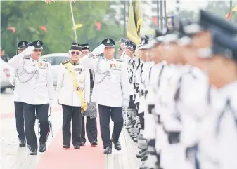  ??  ?? Taib (facing camera, centre) inspects the guard-of-honour – one of the programme line-up held in connection with the special State Legislativ­e Assembly sitting, held to mark its 150th anniversar­y.