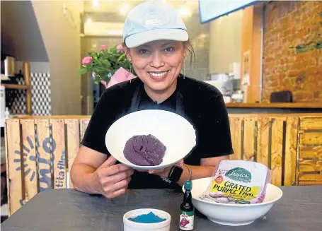  ?? KARON LIU TORONTO STAR ?? Diona Joyce, of Kanto by Tita Flips, shows off the different ways ube can be found in the city: ube halaya, powdered ube, frozen grated ube and ube extract.
Fresh ube is a rarity in Canada and odds are most people have never seen one.