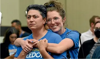  ?? AP ?? Iman Alsaden, chief medical officer for Planned Parenthood Great Plains, and Kelsey Rhodes of Kansas City hug as they and Kansans for Constituti­onal Freedom supporters celebrate a victory at the polls.
