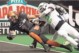  ?? PHOTOS BY MICHAEL CHOW/THE REPUBLIC ?? The Rattlers’ Jamal Miles (left) scores while being tackled by the Nebraska Danger’s Najee Bright Sunday in Phoenix.