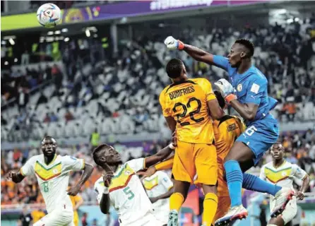  ?? /ALEX GRIMM/GETTY IMAGES ?? Senegal goalkeeper Edouard Mendy punches the ball away during the Fifa World Cup Group A match against Netherland­s at Al Thumama Stadium this week.