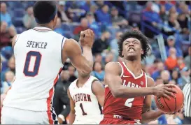  ?? Jeff Roberson / AP ?? Alabama’s Collin Sexton (right) heads to the basket as Auburn’s Horace Spencer defends during the second half of Friday’s game at the Southeaste­rn Conference Tournament.