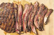  ?? CHRISTOPHE­R TESTANI Food styled by Simon Andrews/The New York Times ?? Flank steak. Lidey Heuck’s recipe includes a marinade of garlic, red wine vinegar and Dijon mustard that comes together easily and plays well with a broad array of possible sides.