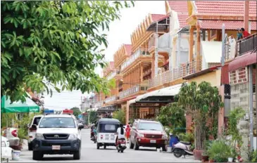  ?? POST STAFF ?? Police vehicles sit outside a house where Montagnard asylum seekers are housed in Phnom Penh.