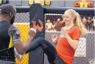  ?? ADOLPHE PIERRE-LOUIS/JOURNAL ?? UNM women’s soccer director of player management Terryn Dyche, right, practices a kick with Jackson-Wink fighter Chris Brown during a workout Tuesday.