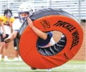  ?? STAFF PHOTO BY C.B. SCHMELTER ?? Boyd Buchanan’s Tyler Moore practices tackling on Monday.