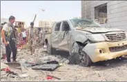  ?? AFP ?? People inspect debris at the site of a suicide car bombing on Monday at an army recruitmen­t centre in Aden.