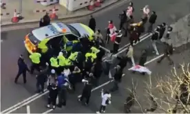  ?? ?? Clashes between police and protesters in Westminste­r as officers use a vehicle to escort Starmer to safety on 7 February. Photograph: Conor Noon/PA