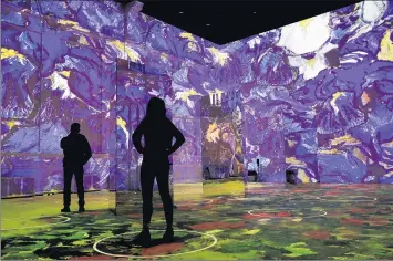  ?? CHRIS SWEDA/CHICAGO TRIBUNE ?? Moving digital images are cast on the floor and walls of Lighthouse ArtSpace as the “Immersive Van Gogh” exhibit is previewed by visitors in Chicago on Feb. 9. Because the show is digital, it was possible to extend performanc­e hours.