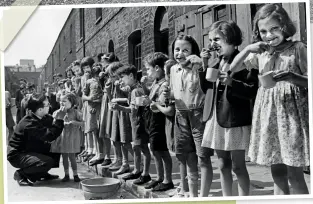  ??  ?? ABOVE Dental hygiene was another important lesson for the younger generation, as shown in this East End teeth-cleaning parade in 1941
