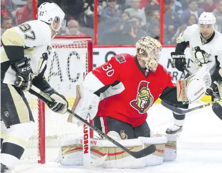  ?? JEAN LEVAC ?? Senators goaltender Andrew Hammond makes the save on Sidney Crosby during the second period Tuesday night at Canadian Tire Centre.