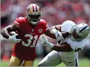  ?? AP PHOTO BY JED JACOBSOHN ?? San Francisco 49ers running back Raheem Mostert (31) runs against Las Vegas Raiders linebacker Max Richardson, right, during the first half of an NFL preseason football game in Santa Clara, Calif., Sunday, Aug. 29.