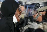  ?? JOHN MINCHILLO — THE ASSOCIATED PRESS ?? A protester yells at a member of the Minnesota National Guard on Friday in Minneapoli­s.