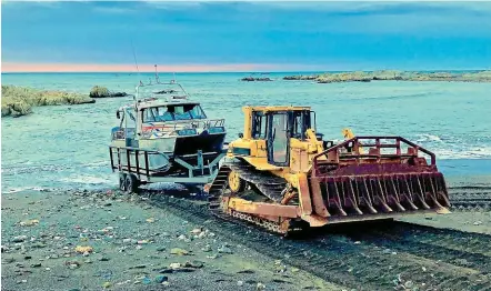  ?? SUPPLIED ?? Burkhart Fisheries using a causeway to launch its boats from Ward Beach in May, 2018.