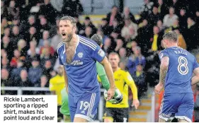  ??  ?? Rickie Lambert, sporting a ripped shirt, makes his point loud and clear