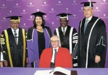  ?? Picture: SID PENNEY ?? TOP HONOURS: The ‘top brass’ of Rhodes University were present when University of Cape Town academic developmen­t director Professor Ian Scott, seated, signed the honorary doctorate register at the first of six graduation ceremonies at the 1820 Settlers National Monument last week. Standing are, from left, Honourable Justice Lex Mpati (chancellor), Dr Adele Moodly (registrar), Dr Sizwe Mabizela (vice-chancellor) and Dr Peter Clayton (deputy vice-chancellor)