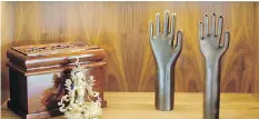  ??  ?? A new built-in next to the living room fireplace displays two copper forearm shapes (once used as glove moulds) and a figure of the Buddhist deity Tara.