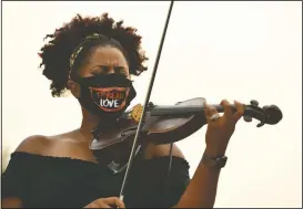  ??  ?? Monique Brooks-Roberts plays “Some Day We Will All Be Free” during the Gathering in Gratitude event.
(The Denver Post/Helen H. Richardson)