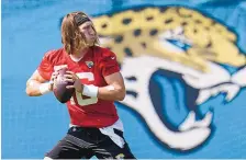  ?? JOHN RAOUX/ASSOCIATED PRESS ?? Clemson All-American Trevor Lawrence, here participat­ing in a drill on the Jacksonvil­le Jaguars’ practice field, on Monday signed his rookie contract with the Jags.