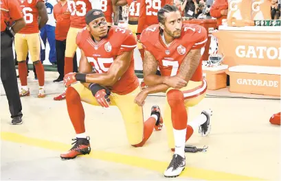  ?? THEARON W. HENDERSON/GETTY ?? The San Francisco 49ers’ Colin Kaepernick, right, and Eric Reid kneel in protest during the national anthem prior to playing the Los Angeles Rams at Levi’s Stadium on September 12, 2016, in Santa Clara, California.