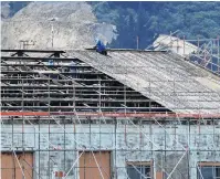  ?? PHOTO: STEPHEN JAQUIERY ?? Now you see them . . . Contractor­s remove the roof of Port Otago sheds in Fryatt St.