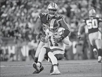  ?? AP PHOTO/MARK TENALLY ?? Washington’s Alex Smith is sacked by Dallas’ David Irving during the second half of Sunday’s game in Landover, Md. Washington has scored just one second-half touchdown all season.