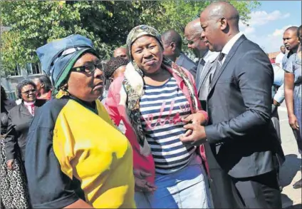  ?? Photo: Veli Nhlapho/Sowetan/Gallo Images ?? Under pressure: Mzwandile Masina, seen comforting relatives of ANC members who died in a tragic bus crash, is now at the centre of a row over the Ekurhuleni party lists.