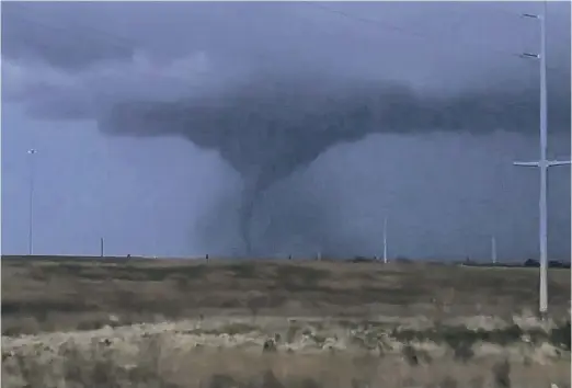  ?? AMY LEIKER/THE WICHITA EAGLE VIA AP ?? A tornado passes through south-central Kansas on April 29 in southeast Wichita.