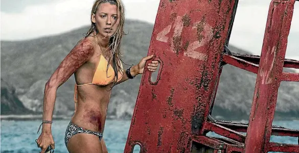  ??  ?? The Shallows is a terrific showcase for Blake Lively, who performs the bulk of the stuntwork and skilfully judges the emotional demands of her role as a vacationin­g surfer trapped in a precarious, single-location scenario that Hitchcock would’ve...