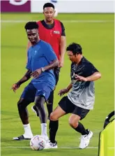  ?? ?? Guard: Police on camels patrol England base yesterday. Right, Bukayo Saka and migrant player