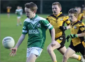  ??  ?? Paul Walsh of St. James’ is chased by Kilrush duo Adam Donohoe and Ben Walsh.