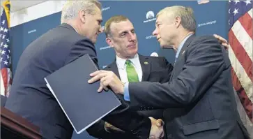  ?? Susan Walsh Associated Press ?? HOUSE MAJORITY LEADER Kevin McCarthy (R-Bakersfiel­d), left, congratula­tes Reps. Tim Murphy (R-Pa.), center, and Fred Upton (R-Mich.) after the vote to approve the 21st Century Cures Act.