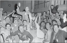  ?? PRESTON STROUP — THE ASSOCIATED PRESS ?? The Cleveland Rams celebrate in their dressing room after they beat the Lions at Detroit to clinch the Western Division championsh­ip Nov. 22, 1945. Coach Adam Walsh, top, is shown waving his hat.