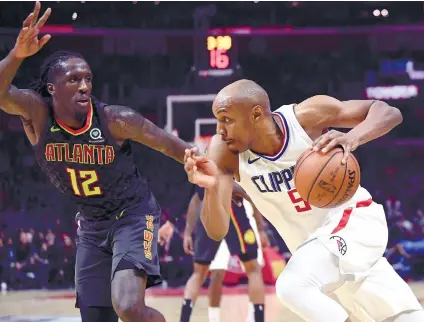  ?? AP FOTO ?? TAKING A SHOT. Los Angeles Clippers guard CJ Williams (rught) drives by Taurean Prince, Atlantan Hawks forward. He shot three points in the last nine seconds of the game, lifting the Clippers against the Hawks, 108107.