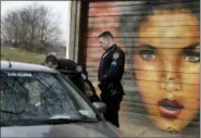  ?? THE ASSOCIATED PRESS ?? In this Tuesday photo, Sgt. Timothy Cecchini, right, and police officer Jimmy Priore check on the occupants of a vehicle while patrolling in the 75th Police Precinct in the Brooklyn borough of New York.