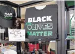  ?? MARLA BROSE/.JOURNAL ?? “Black Olives Matter” merchandis­e is shown at Paisano’s Italian Restaurant in Albuquerqu­e.