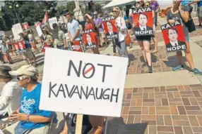  ?? Helen H. Richardson, The Denver Post ?? People hold up signs during a rally to protest President Donald Trump’s Supreme Court nomine, Brett Kavanaugh, at Civic Center Park on Sunday.