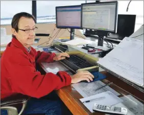  ?? LAURA JEAN GRANT - CAPE BRETON POST ?? John MacKinnon, a weather observer at the J.A. Douglas McCurdy Sydney Airport, keeps an eye on the weather and the data coming into the station Monday morning. A weather observer is stationed in the airport tower 24 hours a day, seven days a week.