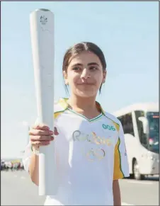  ??  ?? Hanan Dacka carrying the Olympic torch