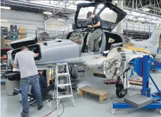  ?? MORRIS LAMONT/ FILES ?? Workers at Diamond Aircraft assemble a DA62 plane at a factory in London, Ont. Trade in aircraft, metal ores, nonmetalli­c minerals, and other transporta­tion and parts hit record highs in June.