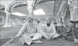 ?? AP ?? Pakistani Sikh Radesh Singh (left) at a gurdwara in Peshawar, Pakistan, on Monday.