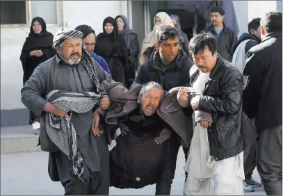  ?? Rahmat Gul ?? A distraught man is carried after a suicide attack Thursday at a Shiite cultural center in Kabul, Afghanista­n. The Associated Press