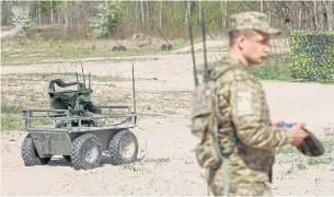  ?? ?? LIVE DEMONSTRAT­ION: A serviceman operates an unmanned ground vehicle during an exhibition at an undisclose­d location in Ukraine on April 13.