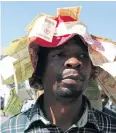  ?? Picture: AFP ?? A man displays old Zimbabwean dollar notes while taking part in a protest against the introducti­on of bond notes in Harare. Tackling the cash crisis will be an immediate priority for Zimbabwe’s next leader.