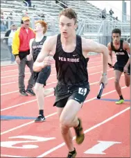  ?? TIMES photograph­s by Annette Beard ?? Junior Blackhawk runner Patrick Elliot raced off on the final leg of a relay race Friday, April 9, after grabbing the baton from his team mate, Owen Harris.