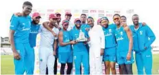  ?? — AFP ?? West Indies players pose with the Wisden trophy at the end of day 4 of the third and final Test against England at Gros Islet, Saint Lucia.