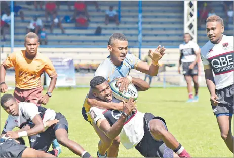  ?? Picture: FILE ?? Saunivalus U20 player Rupeni Sirivakaik­a gets a high tackle by a Ratu Filise opponent during the Fiji Bitter Nawaka 7s tournament at Prince Charles Park in Nadi.