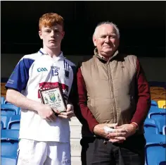  ??  ?? Frank Reynolds of St Pat’s gets his Wicklow People Man of the Match award from Liam O’Loughlin.