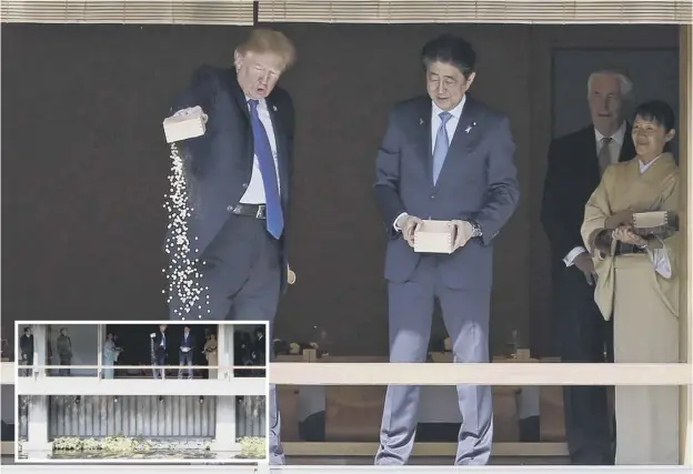  ??  ?? 0 President Donald Trump feeds carp at a koi pond with Japan’s prime minister Shinzo Abe yesterday. Mr Trump said North Korea is ‘a threat to the civilised world’